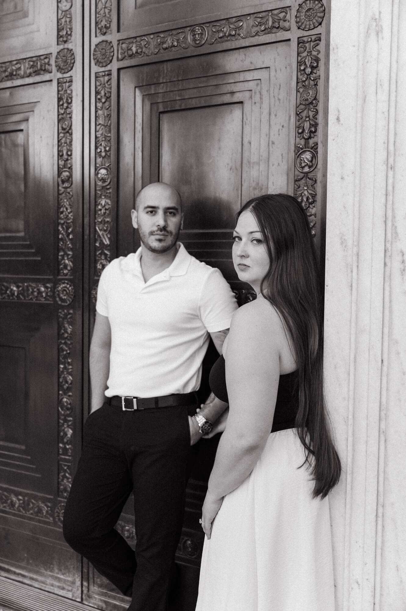 Close portrait of couple standing at the museum entrance.