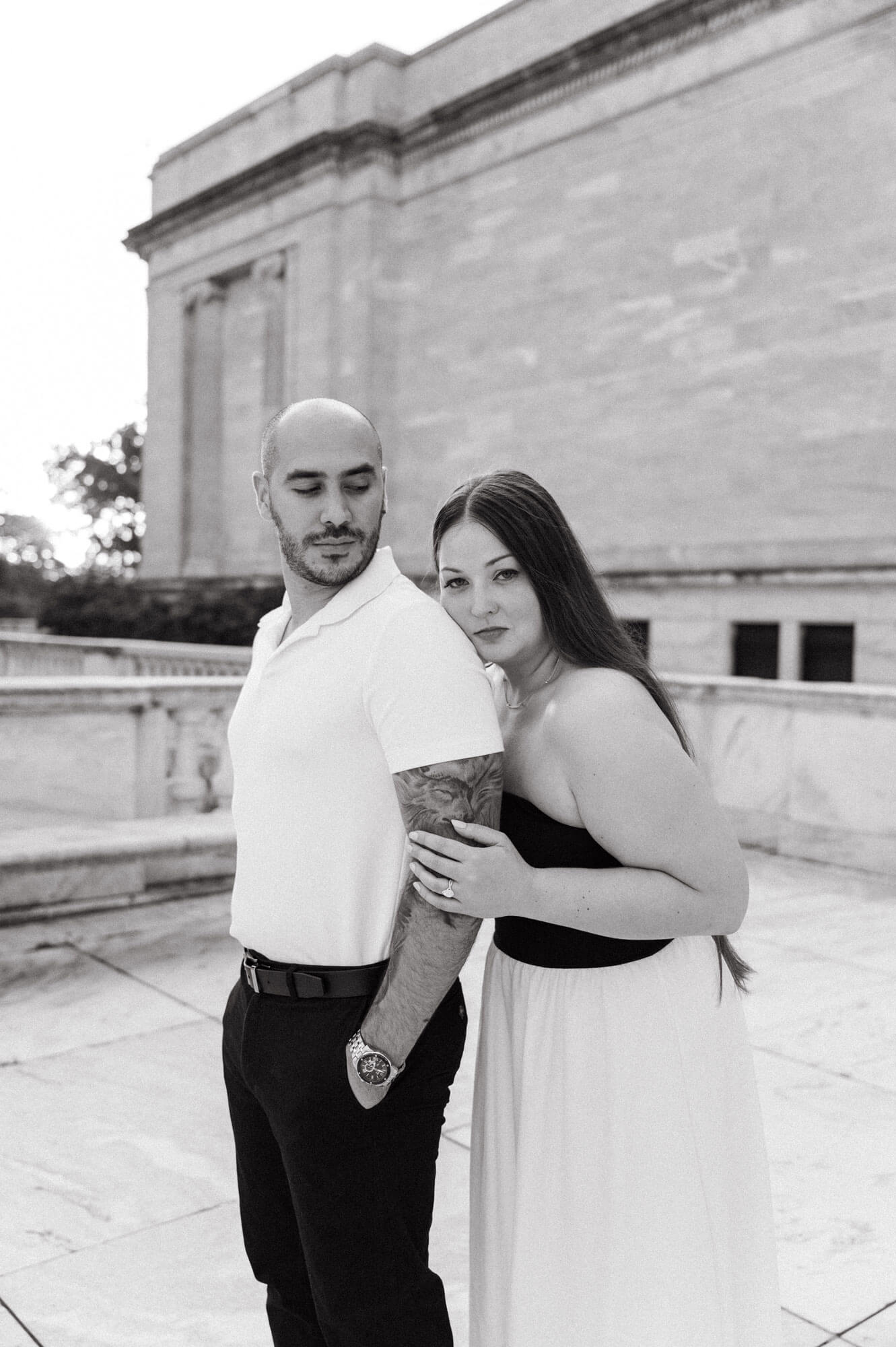 Close portrait of couple embracing near the museum terrace.